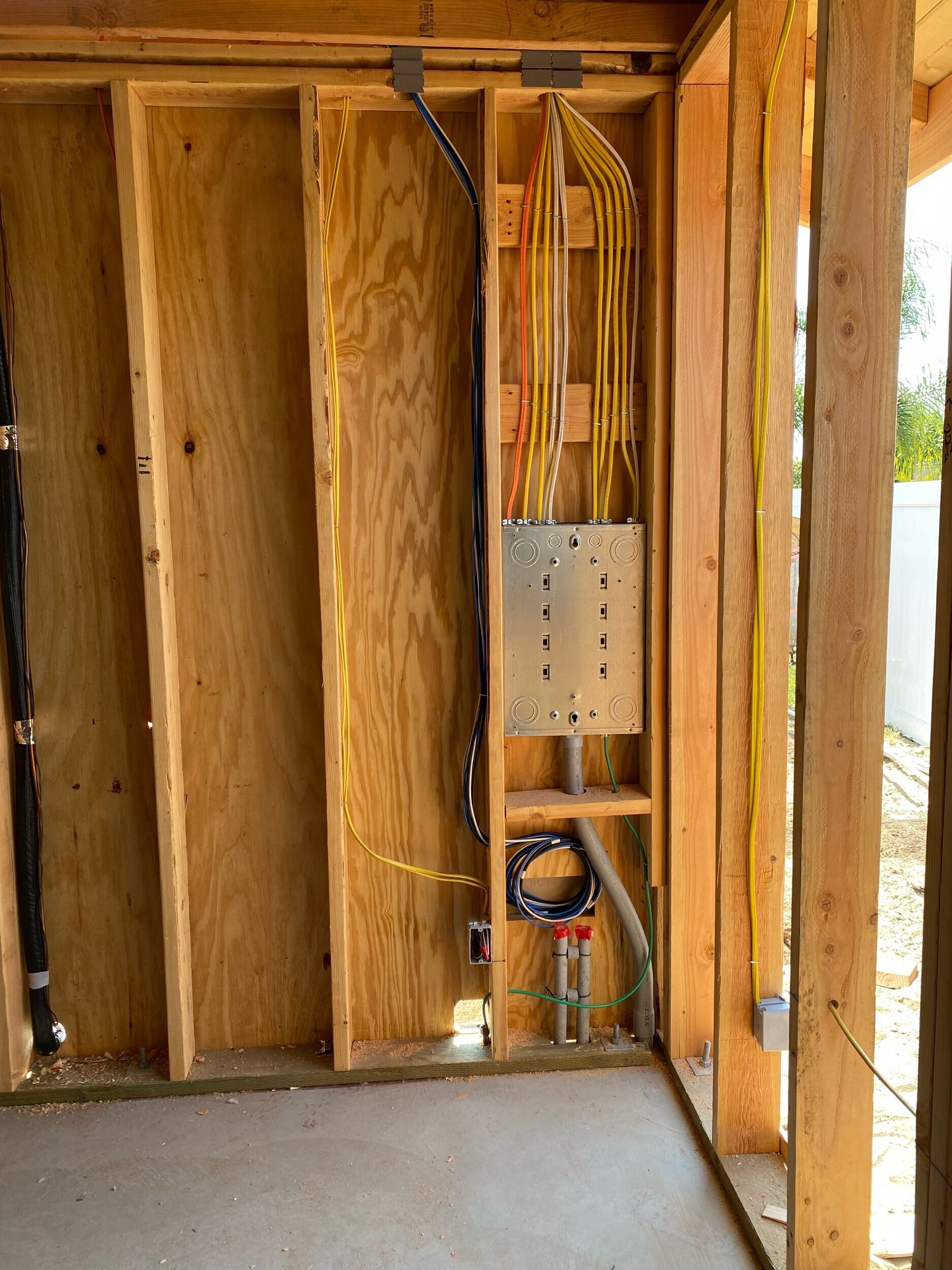 Residential framing with electrical wiring running through the walls. 