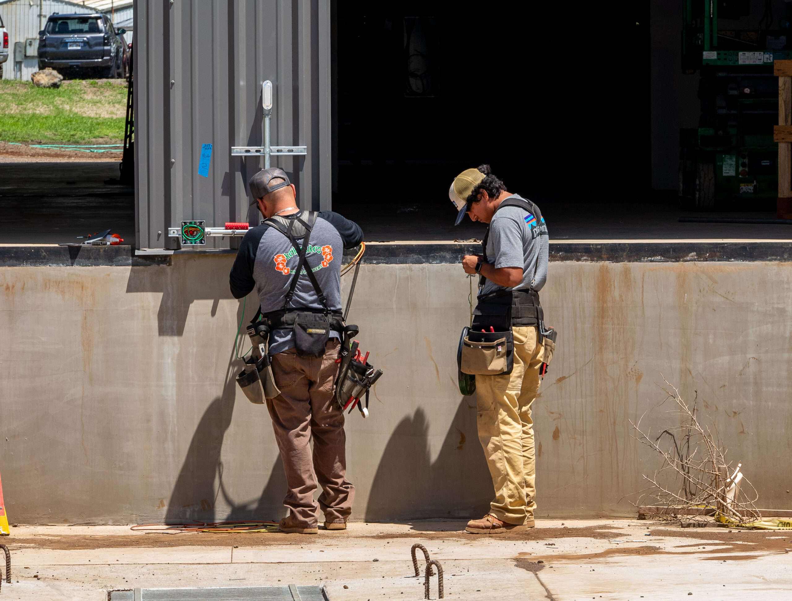 electricians working on an outlet outside