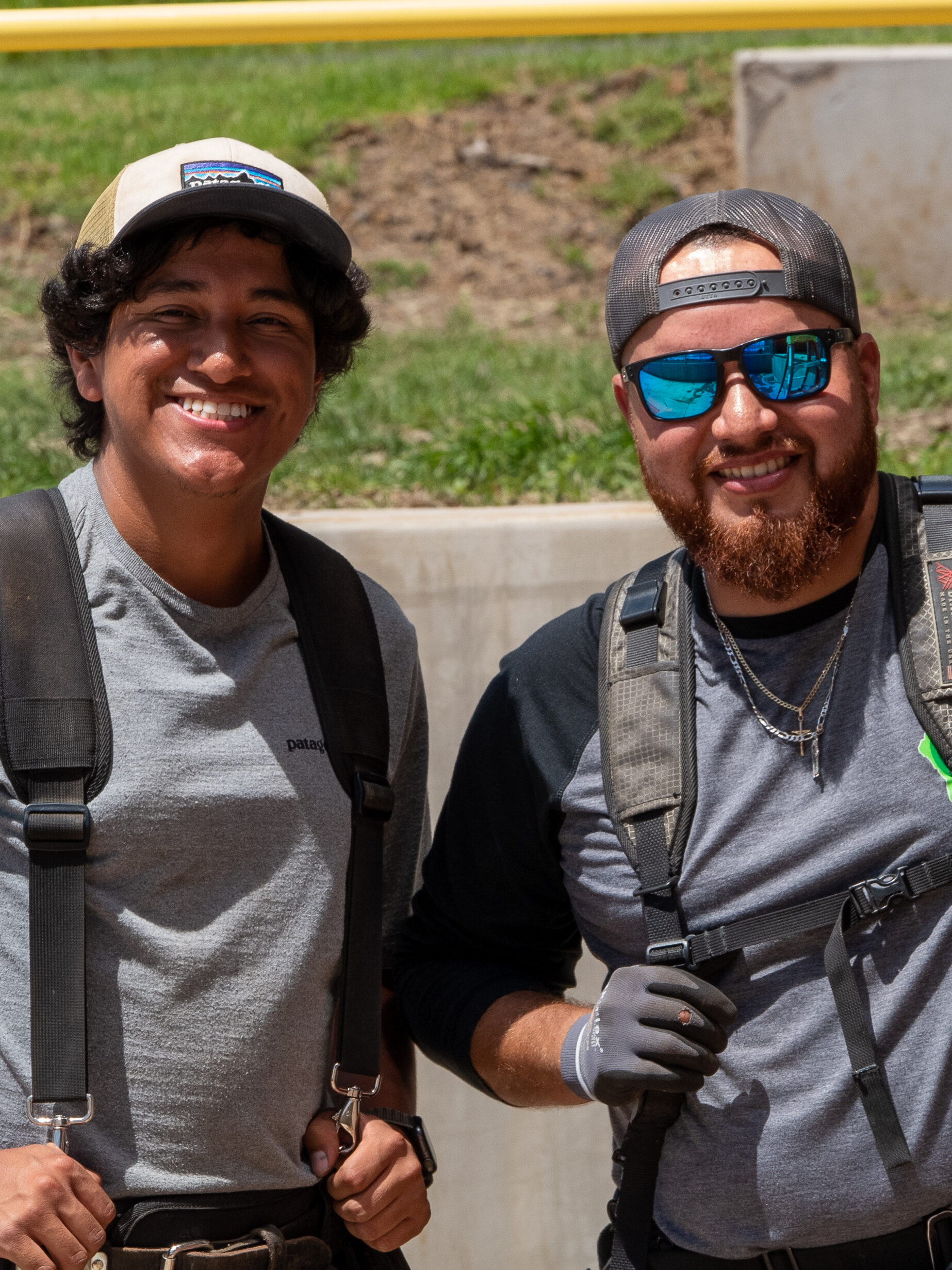 Two Electricians smiling on the job. 